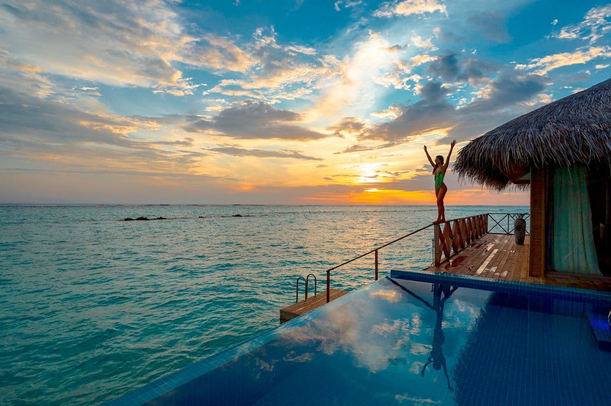 A suite terrace suspended above the Tyrrhenian Sea at dusk