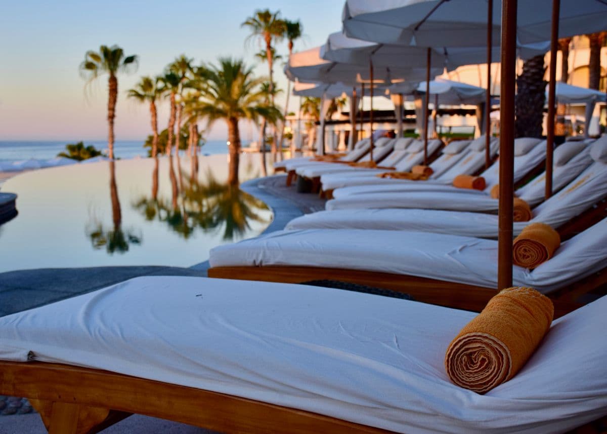 An infinity pool meeting the sea at golden hour